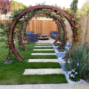 Through the flower circle to the seating area with fire pit.